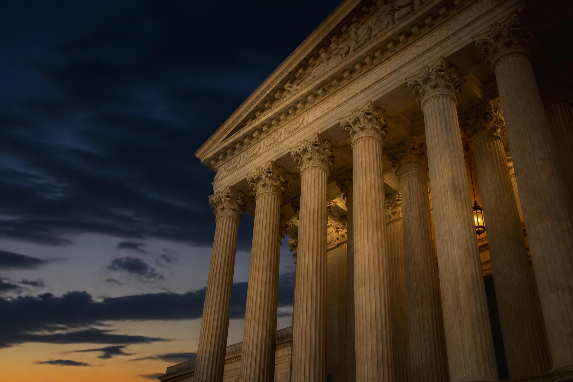 Classical courthouse columns at dusk